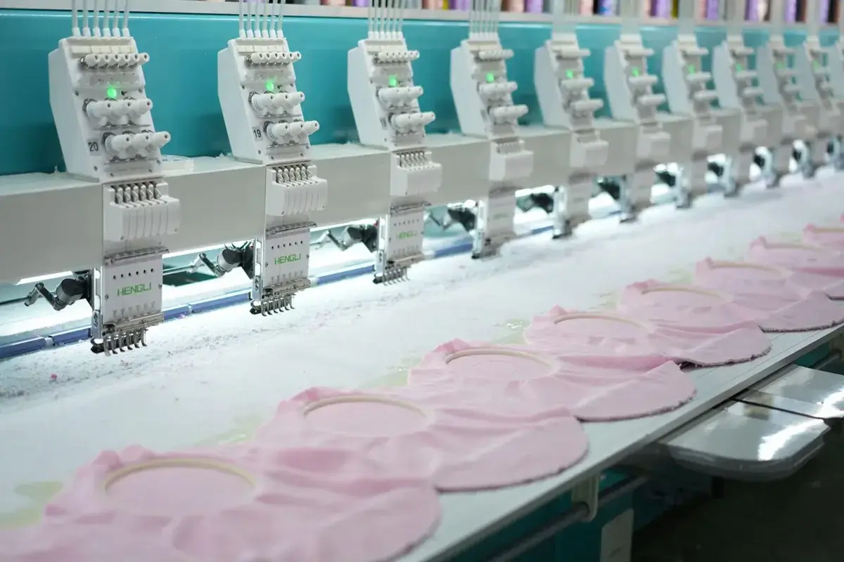 Multi-head embroidery line stitching repeated designs for a bulk towel order