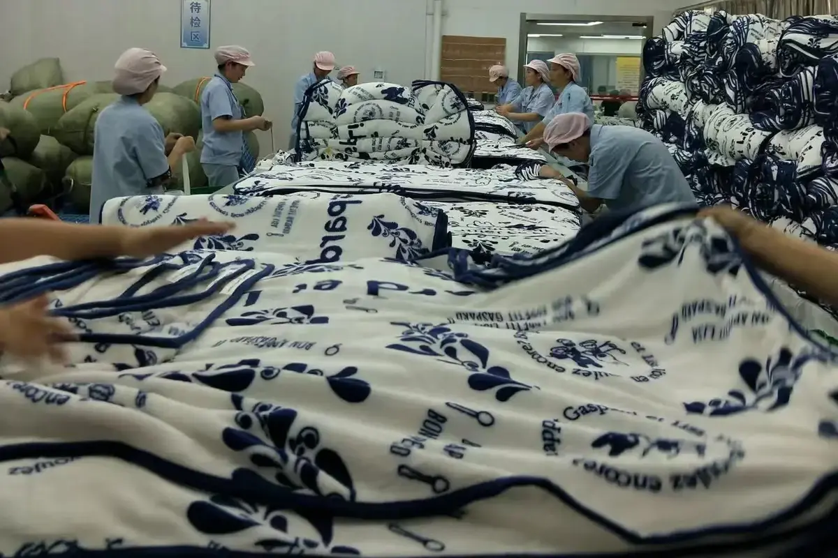 Workers inspecting printed towel fabric during production