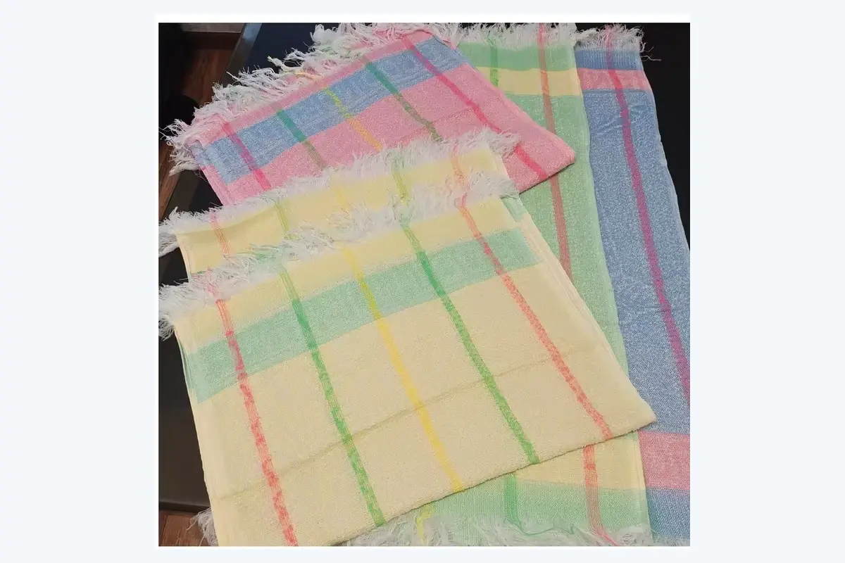 Folded pastel hand towels showing the visible front panel