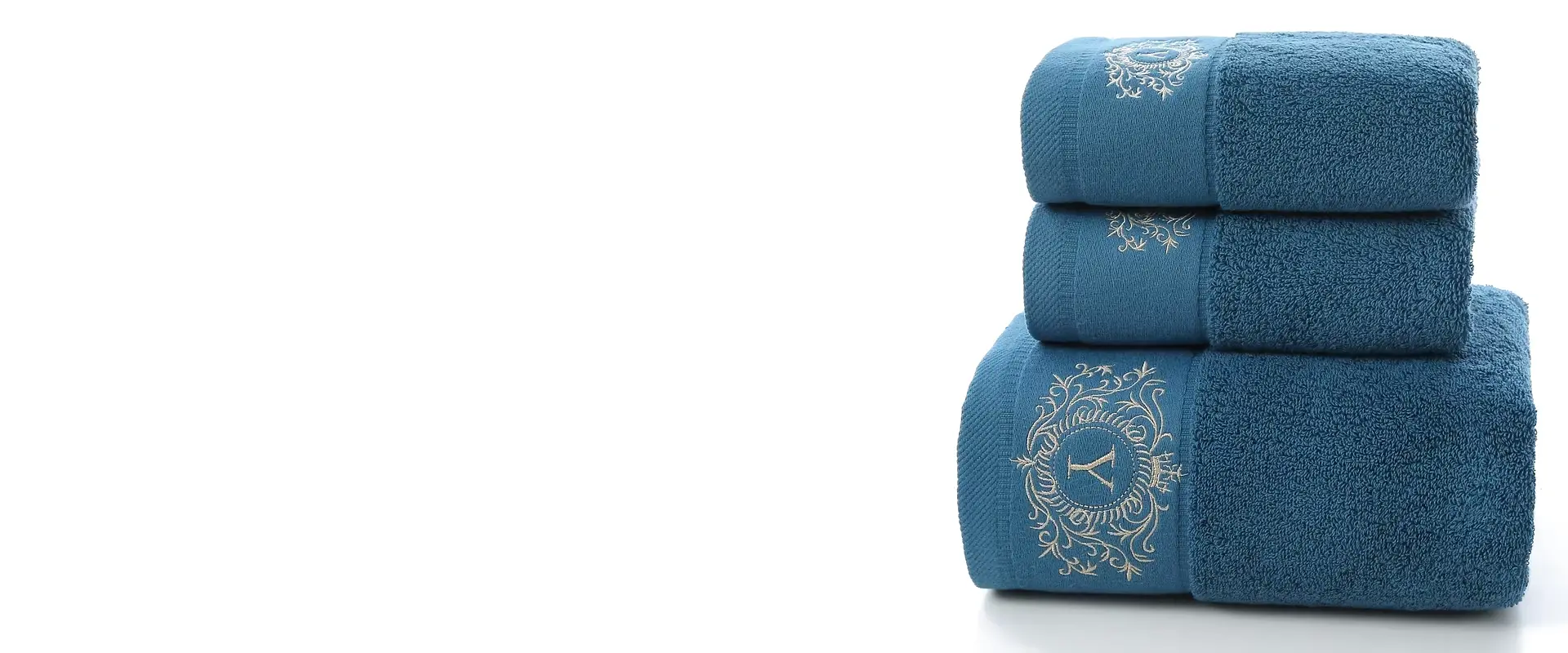 Blue embroidered hotel towel set in bath, hand, and face towel sizes