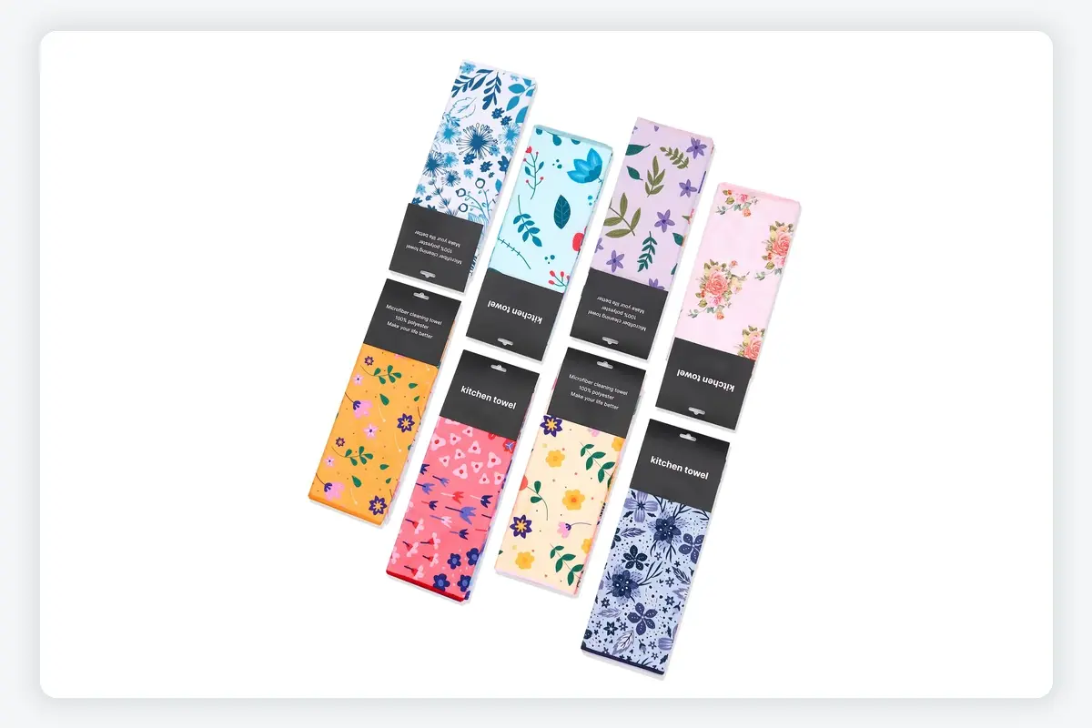 Printed kitchen towels folded into narrow retail packs with black paper bands