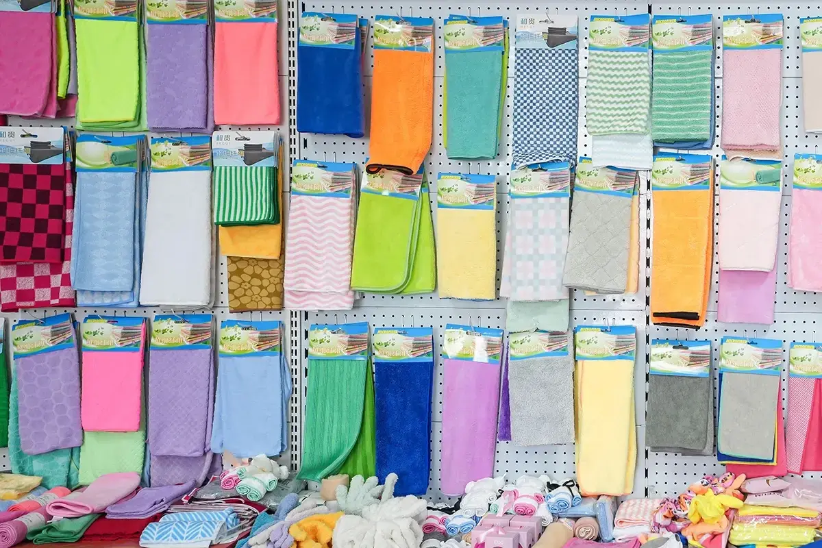Colorful kitchen towels presented in assorted colors, textures, and retail display formats