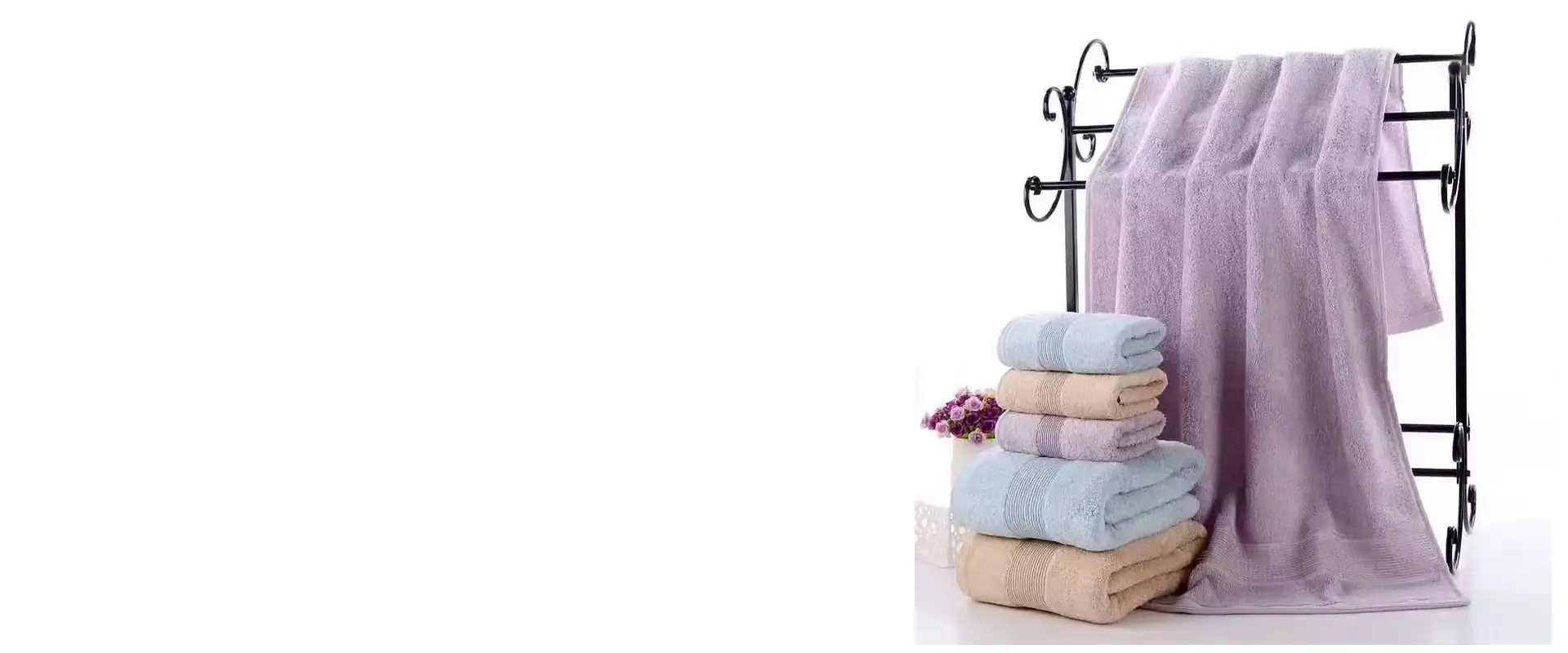 Lavender spa towels displayed on a rack with folded pastel towels