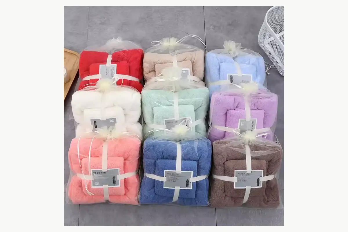 Nine color-coded towel sets prepared in individual clear packaging with paper labels