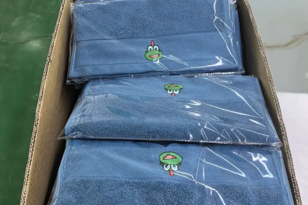 Finished towels with embroidered logo samples prepared for branding review