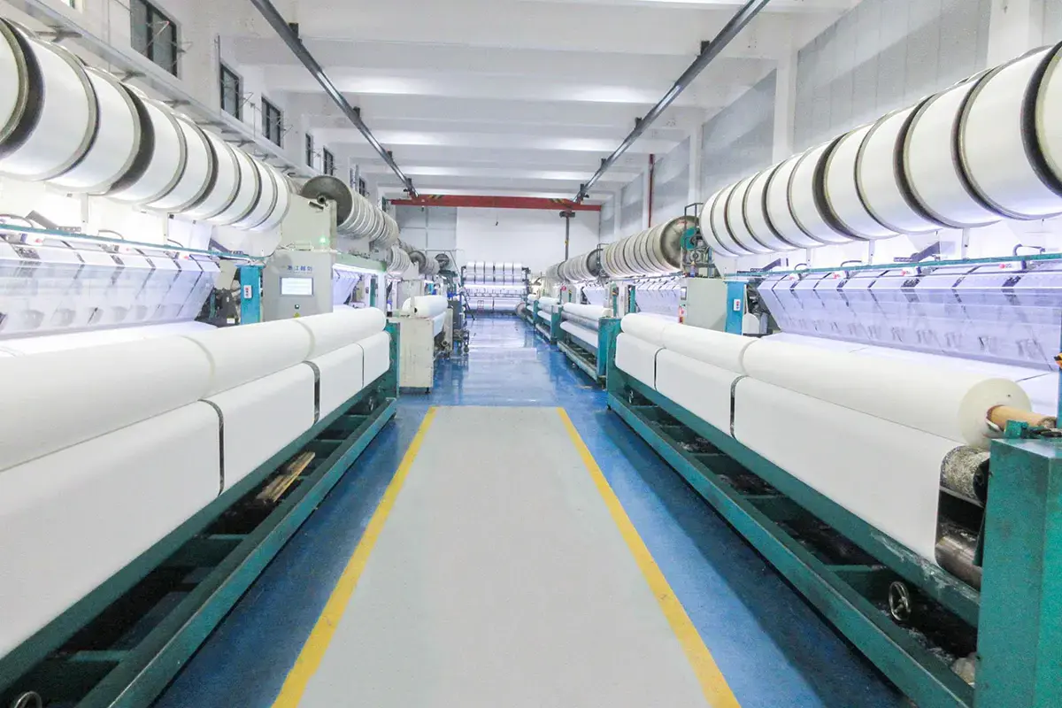 Rows of towel weaving machines producing fabric for custom jacquard designs