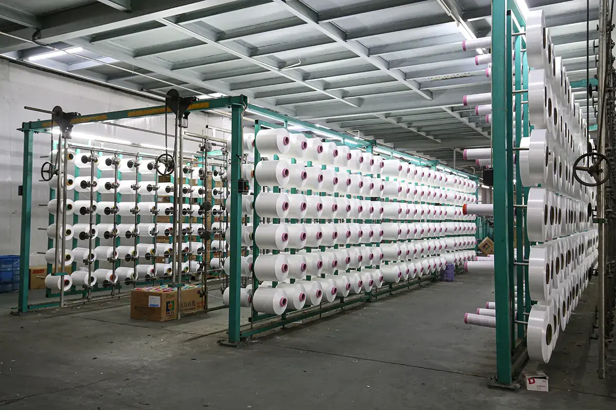 Yarn packages staged for blended towel material production