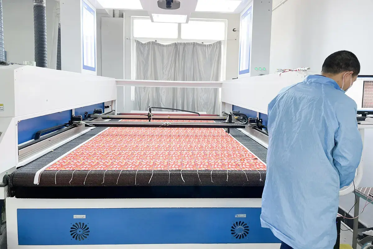 Technician operating a large-format textile printing machine for custom towel artwork