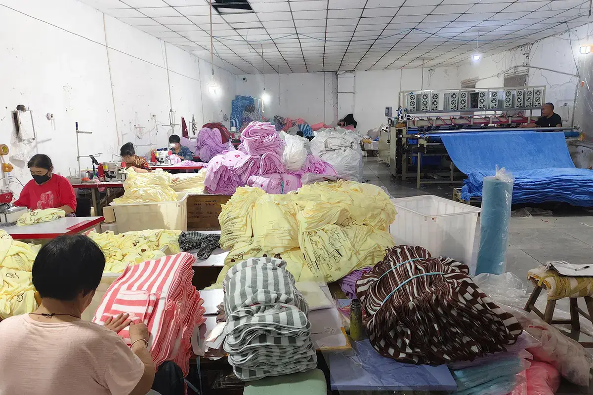 Production team sorting stacks of finished towels during final inspection