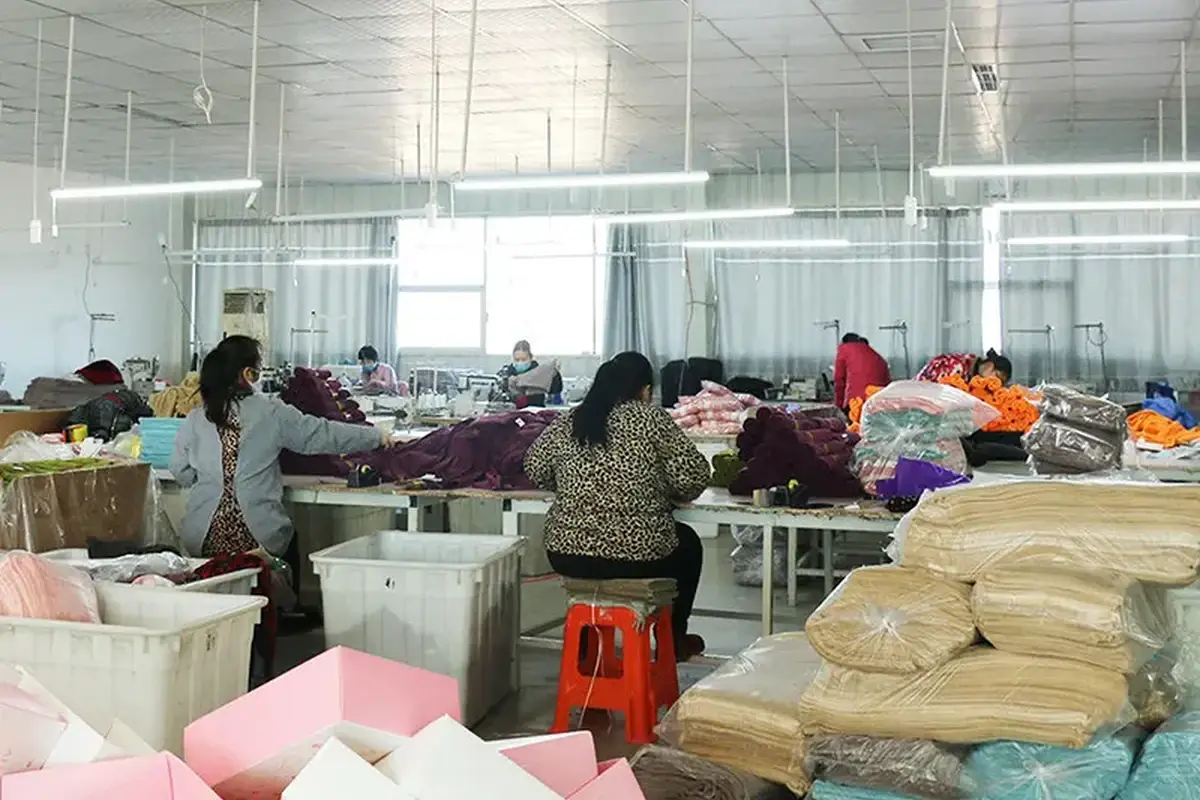 Workers sorting towel materials and finished pieces during production checks