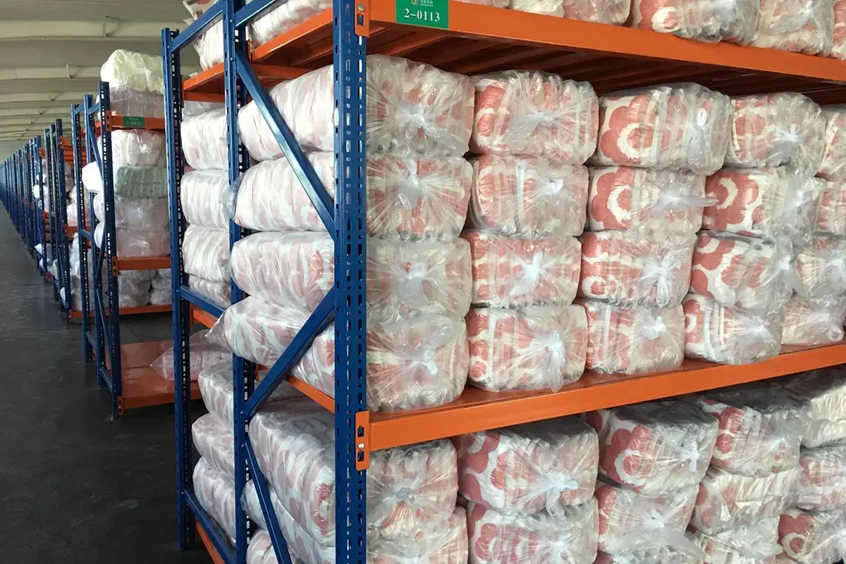 Packed towel goods stored on warehouse racks for shipment preparation