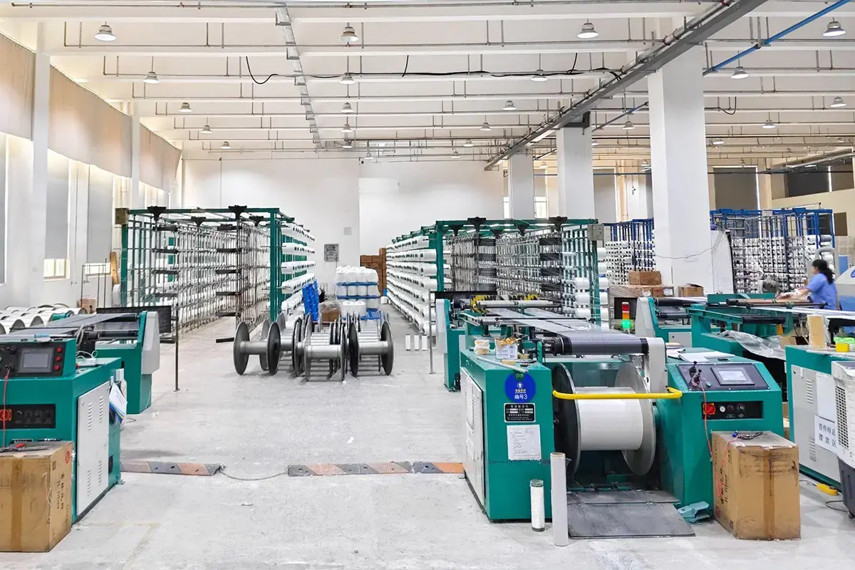 Organized custom towel factory floor with rows of textile production equipment