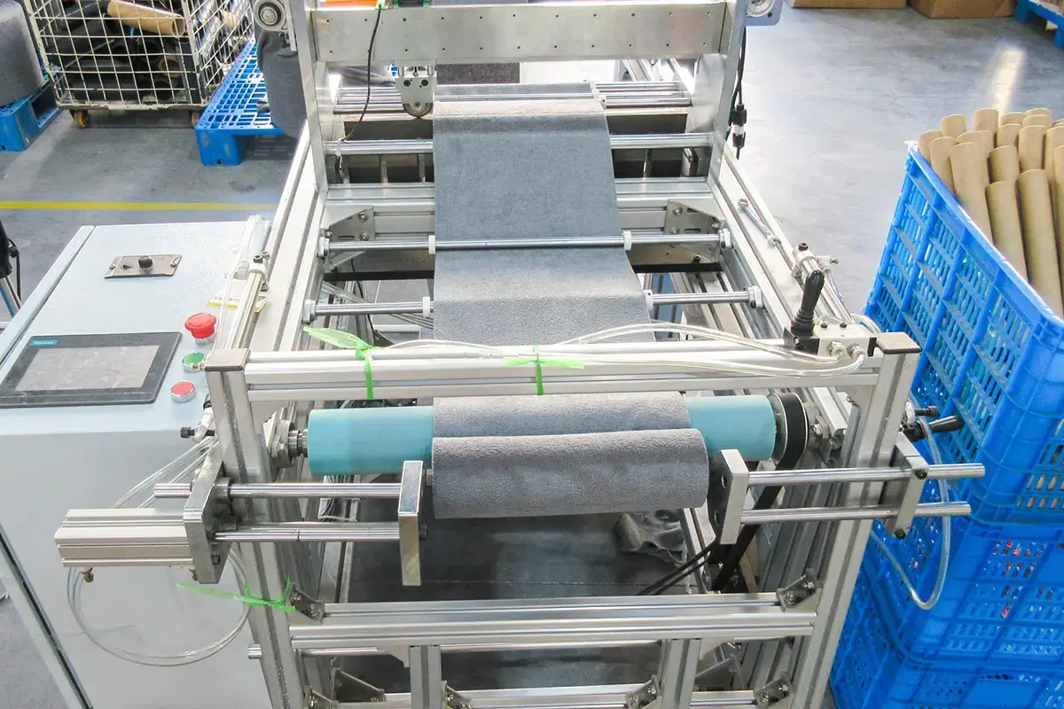 Towel fabric moving through calibrated production equipment for in-process checks