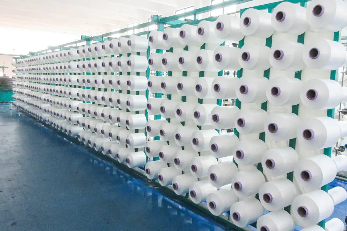 Rows of yarn packages prepared for towel material production and traceability